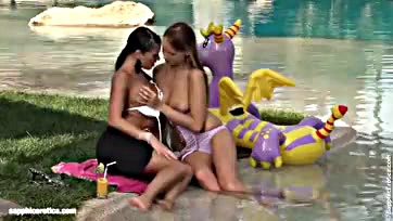 Lesbians passionately finger each other in the pool