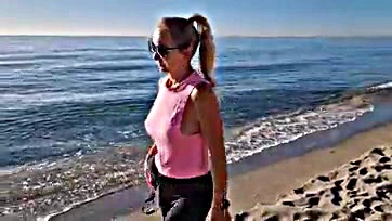 Milf removes bra during beach morning stroll