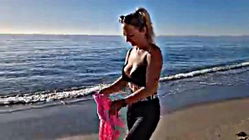 Milf removes bra during beach morning stroll