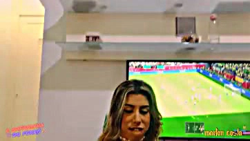 Brasil fan watches game while eating pink snack and flirting