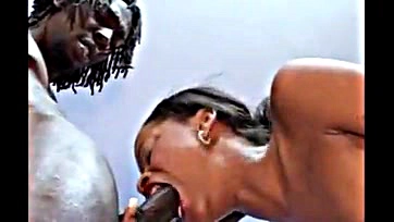 Stud's cock is orally serviced by a black woman