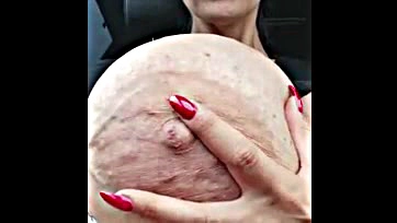 Big-breasted woman displays massive, prominent nipple and vein