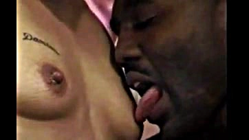 Black woman orally stimulates man's erect penis