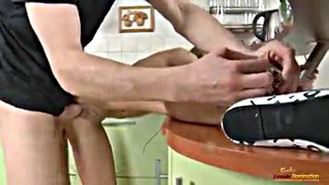 A girl is punished with rough sex in kitchen