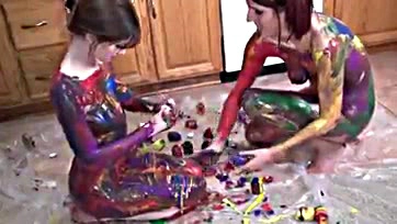 Redheads engage in explicit, paint-covered body rubbing