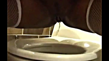 Sexy black woman pees on camera, gets naughty