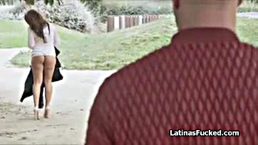 A Latina woman performs oral sex in a park