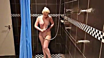 Sexy blonde rubs herself clean in steamy shower