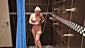 Sexy blonde rubs herself clean in steamy shower