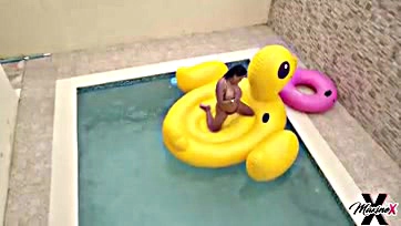 Woman masturbates and cums on rubber ducky in pool