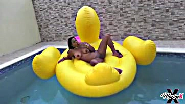 Woman masturbates and cums on rubber ducky in pool