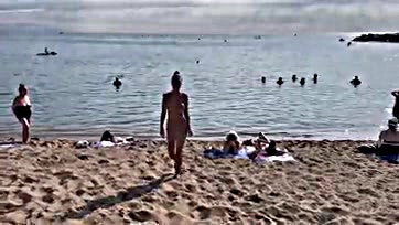 Foxy chick gets naked, swims, and walks on beach