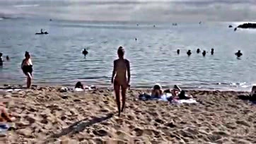 Foxy chick gets naked, swims, and walks on beach