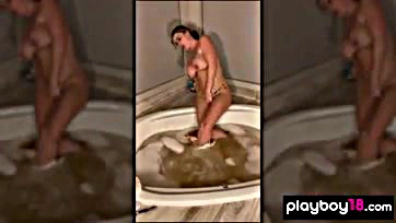 Sophie Dee masturbates solo in a bathtub