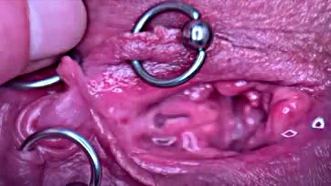 Pierced pussy, pee, and clit in extreme close-up