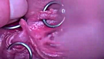 Pierced pussy, pee, and clit in extreme close-up