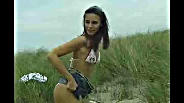 Foxy teen flaunts her bare booty on sandy shore