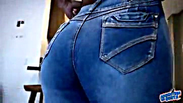 Sexy ebony woman flaunts curvy assets in tight jeans