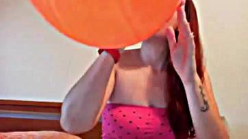 Fetish-themed video with colorful balloons, explicit content