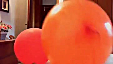 Fetish-themed video with colorful balloons, explicit content