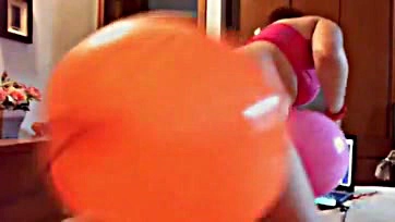 Fetish-themed video with colorful balloons, explicit content