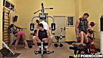 Four women engage in a group sex session at gym