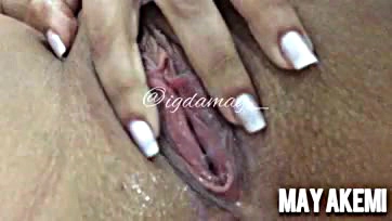 She's playing with her vulva and enjoying herself