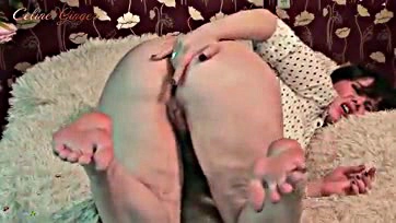 Mature woman fondles her plump buttocks