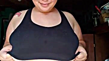 A Latina teen exposes her large breasts on camera