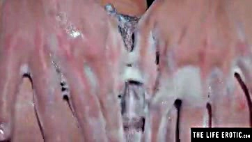 Sexy brunette washes hairy vulva in shower