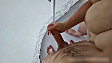 Stepmom jacks off stepson's cock in the shower