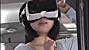 Asian woman caught in bus with VR glasses