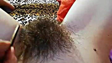 Explicit video showcases hairy vulva and prominent clitoris