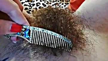 Explicit video showcases hairy vulva and prominent clitoris