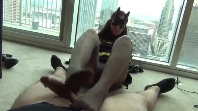 Catwoman gives a footjob