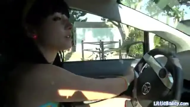 Teen toys her tight cunt in a car