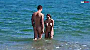 Woman gets intimate with fan at nude beach