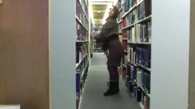 Amateur busty redhead in the library