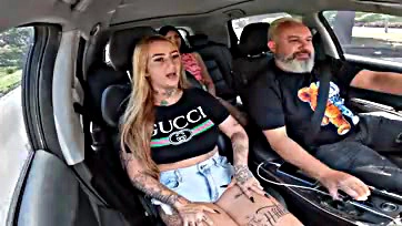 Topless tattooed woman gives a blow job on the road