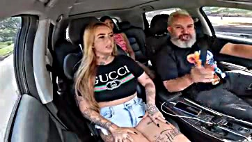 Topless tattooed woman gives a blow job on the road