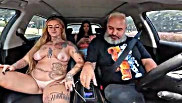 Topless tattooed woman gives a blow job on the road