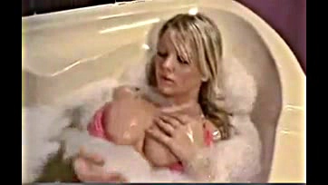 Nude teen plays with massive tits in tub