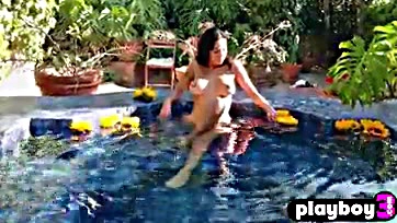 Lily's massive breasts splashed in a sultry pool scene