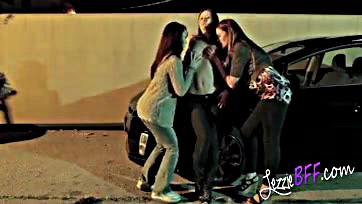 Lady friends get intimate in a public parking lot