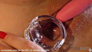 A blonde opens her vulva with a speculum