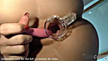 A blonde opens her vulva with a speculum