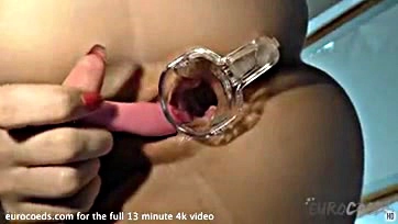 A blonde opens her vulva with a speculum