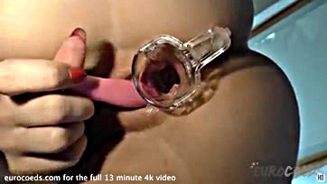 A blonde opens her vulva with a speculum