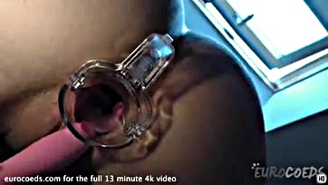 A blonde opens her vulva with a speculum