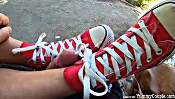 Man publicly jizzes twice on his sneakers